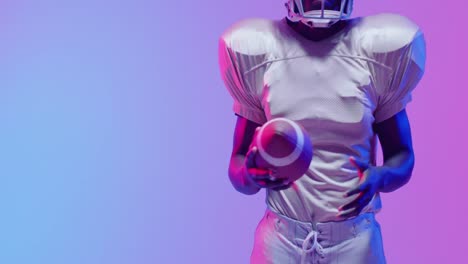 Video-of-african-american-american-football-player-with-copy-space-over-blue-to-pink-neon-background