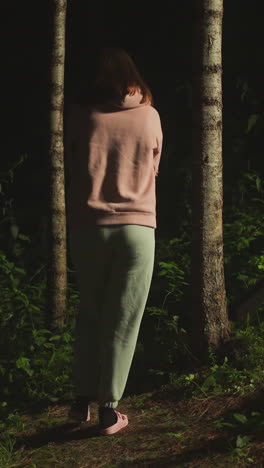 upset lady in warm clothes goes for evening walk along path into forest. young woman enjoying clean air and weekend outside city thinking about problems