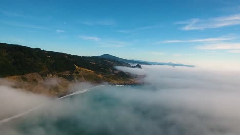 AERIAL:-Flying-through-a-misty-area-the-Oregon-coastline-becomes-increasingly-more-visible