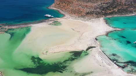 aerial static view balos beach and lagoon with turquoise water, mountains and cliffs in crete, greece