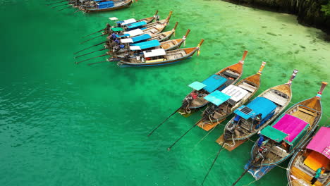 thailand tourist boats moored along maya bay, aerial dolly shot