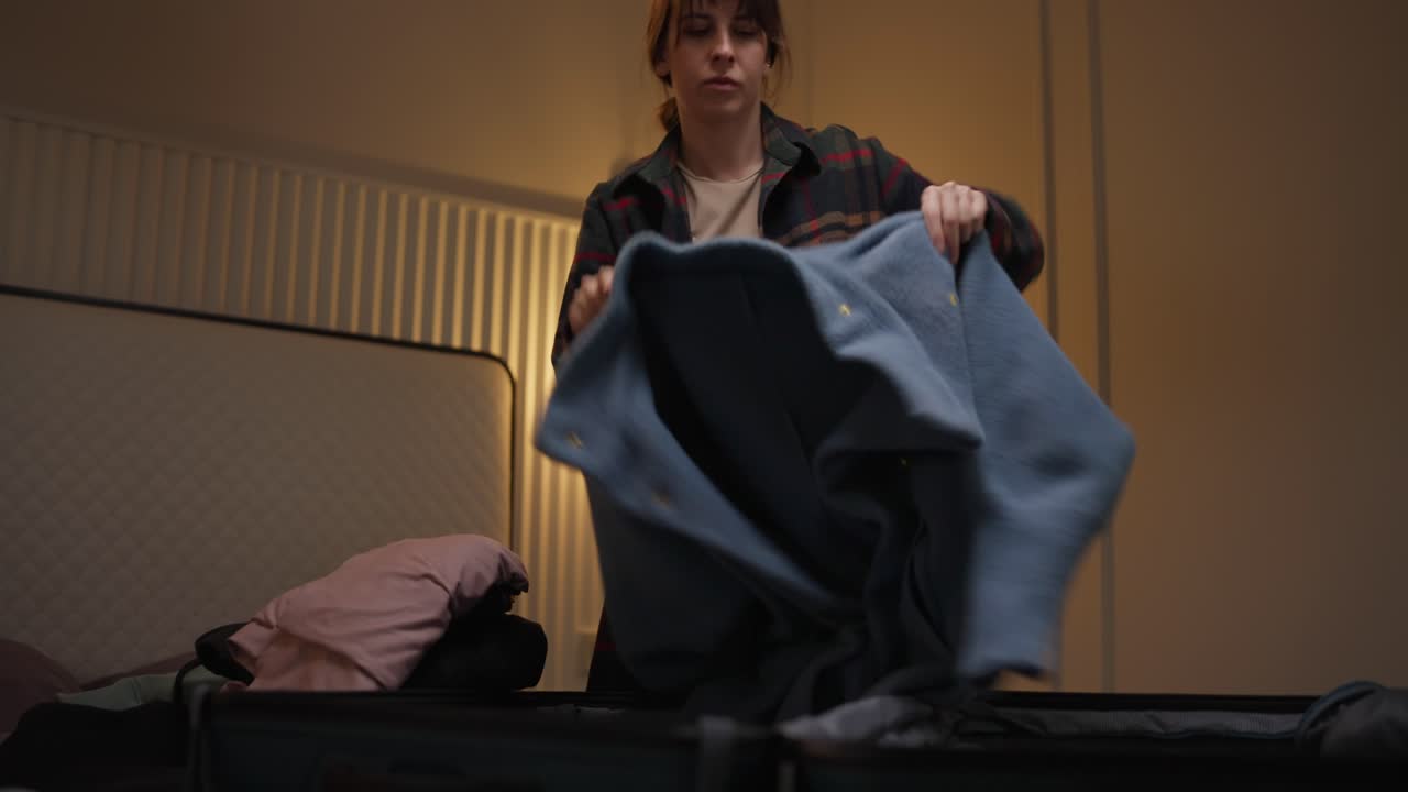 Woman packing suitcase for a trip