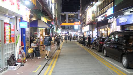 busy city night, where streets gleam bright, vendors sell under neon lights