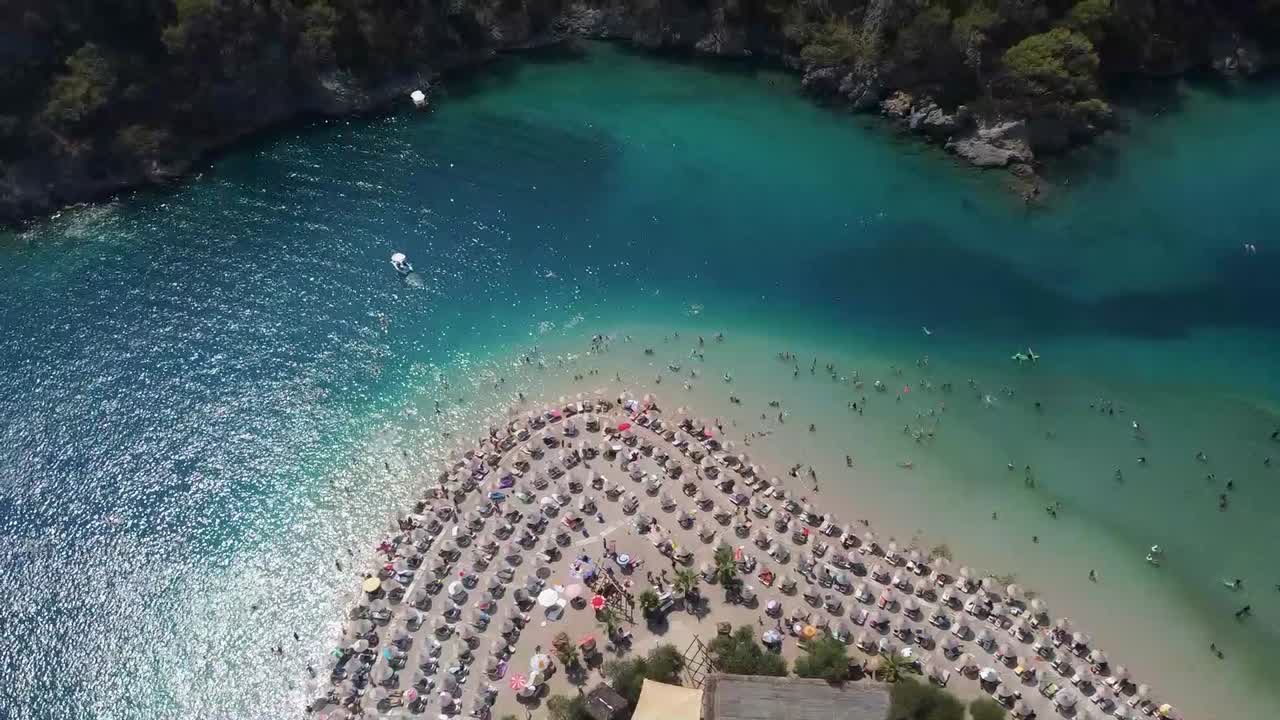 People enjoying their vacations on the beach of Oludeniz on the Turquoise Coast of Turkey
