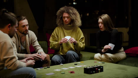 group of friends playing poker sitting on the couch in the living room 6