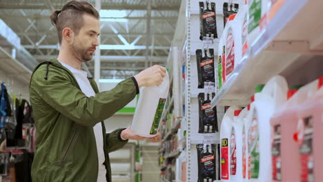 man shopping for automotive supplies in a supermarket