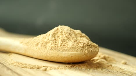 ginger powder on wooden spoon