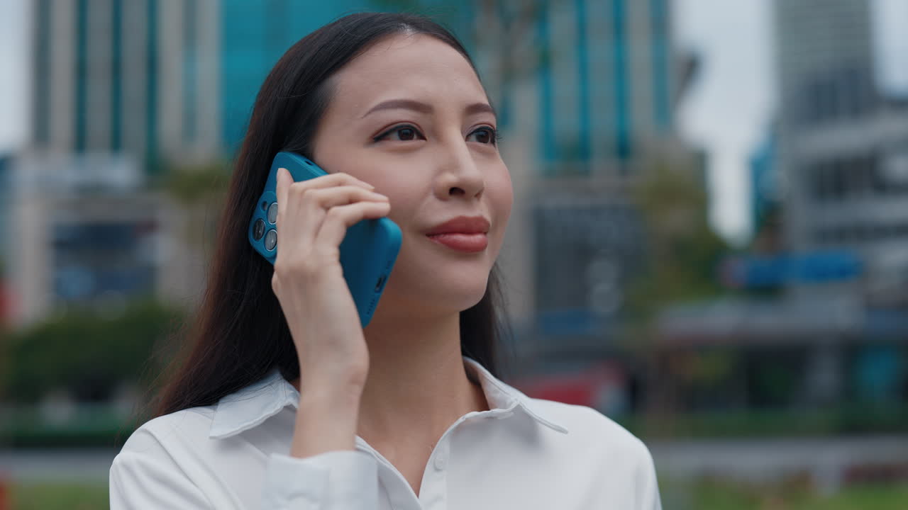 Businesswoman Talking on Smartphone in City