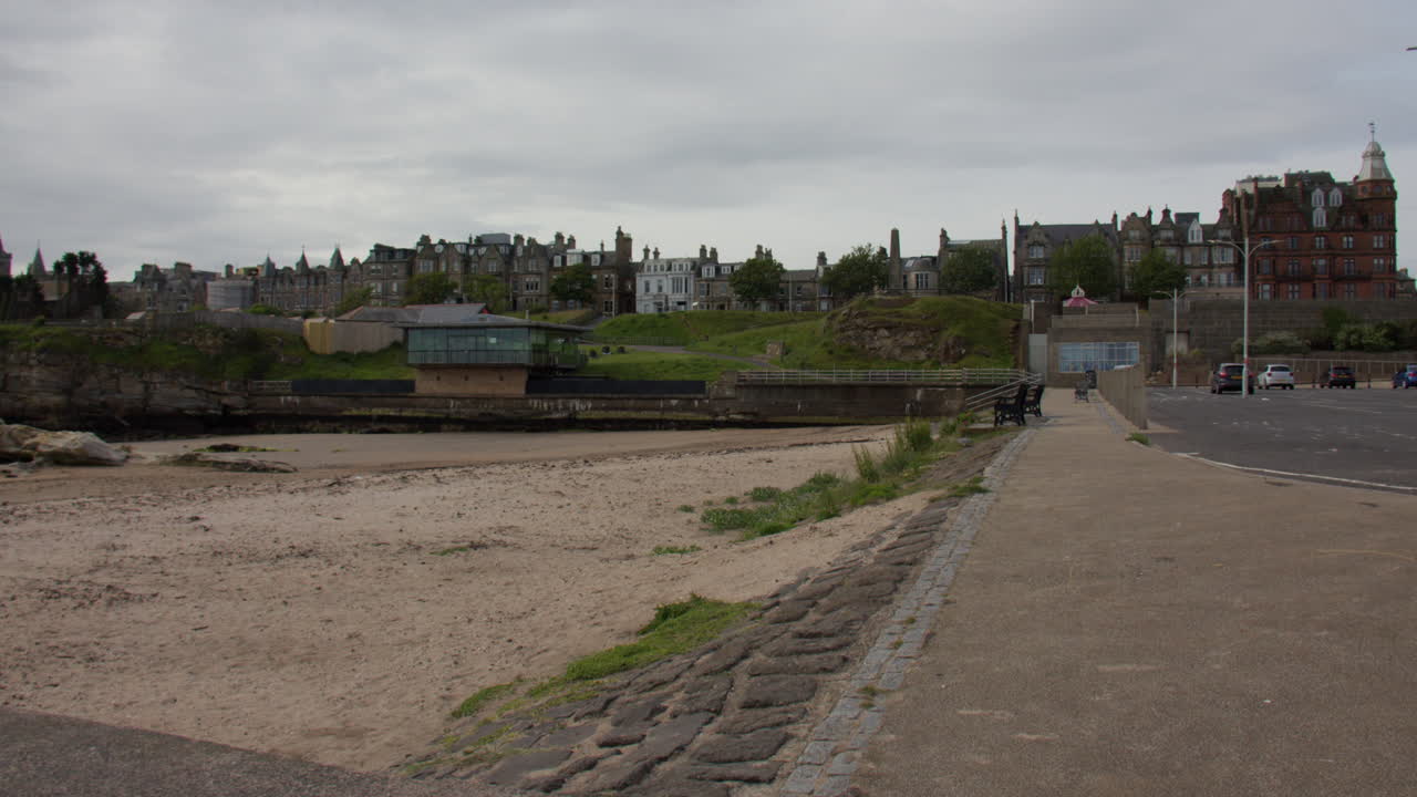 Wide shot looking up to Saint Andrews from bruce Embankment
