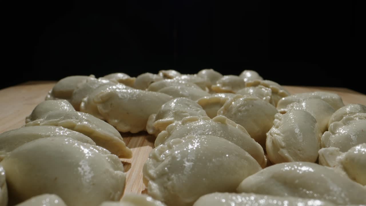 Raw Dumplings on a Wooden Board