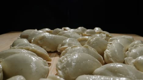 raw dumplings on a wooden board