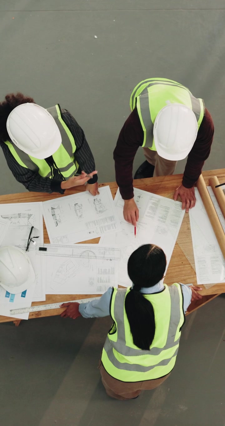 Architects and Engineers Reviewing Construction Blueprints