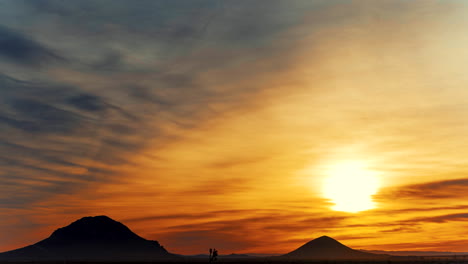 amazingly colorful golden sunrise over the rugged terrain of the mohave desert - time lapse