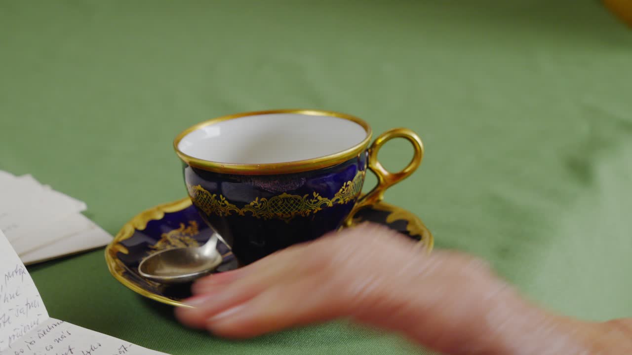 Elegant elderly lady sips tea while reading mail letter at home