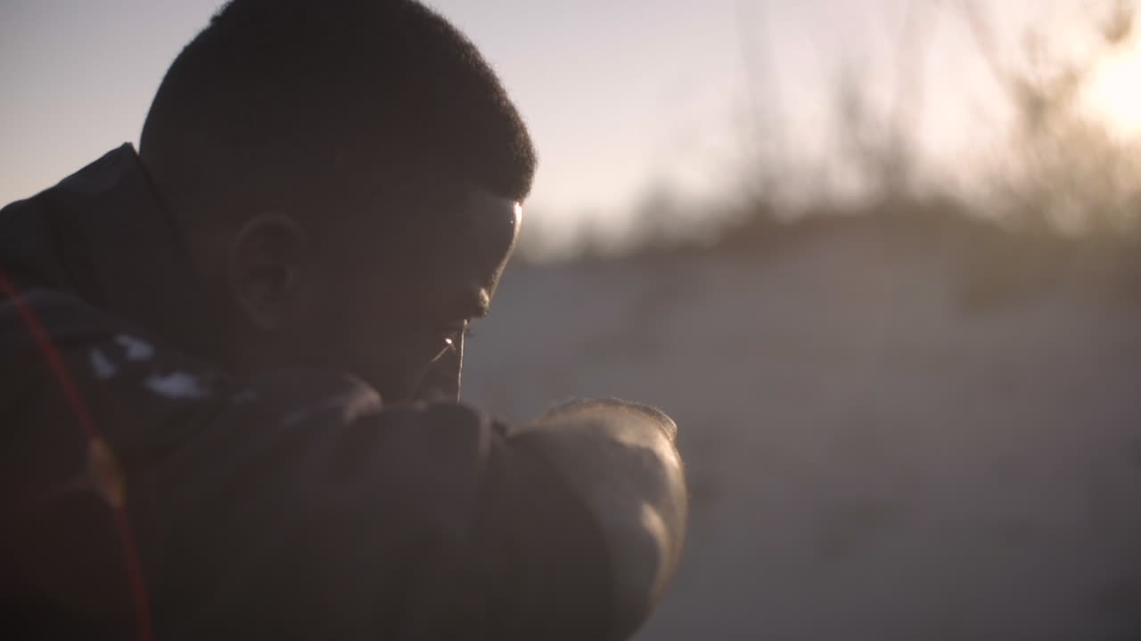 Silhouette of a Man in the Desert at Sunset