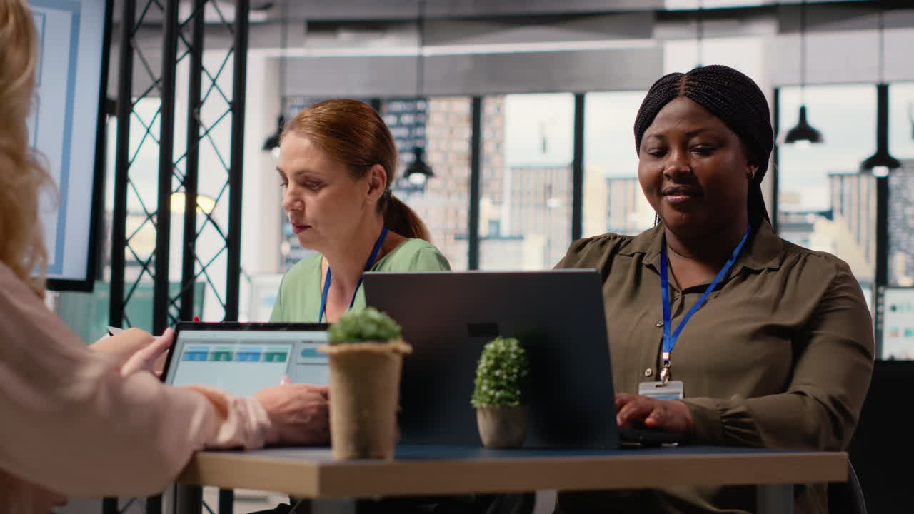 Vertical Video Black businesswoman sitting at boardroom table and solving tasks
