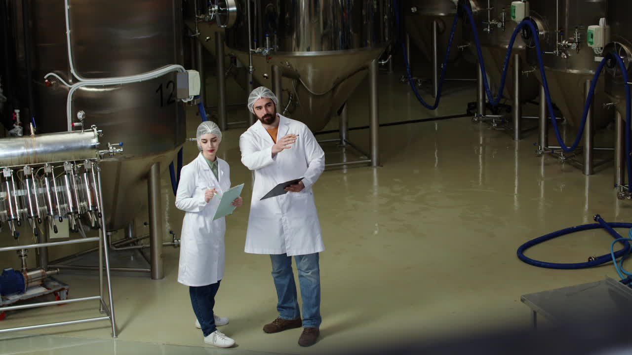 Man and woman doing control at brewery