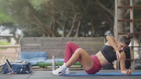 a woman performing various exercises on a mat outdoors