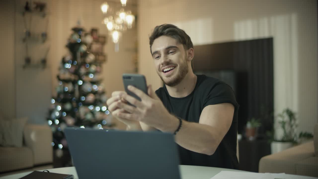 hombre feliz haciendo videollamadas en línea en un teléfono móvil en navidad