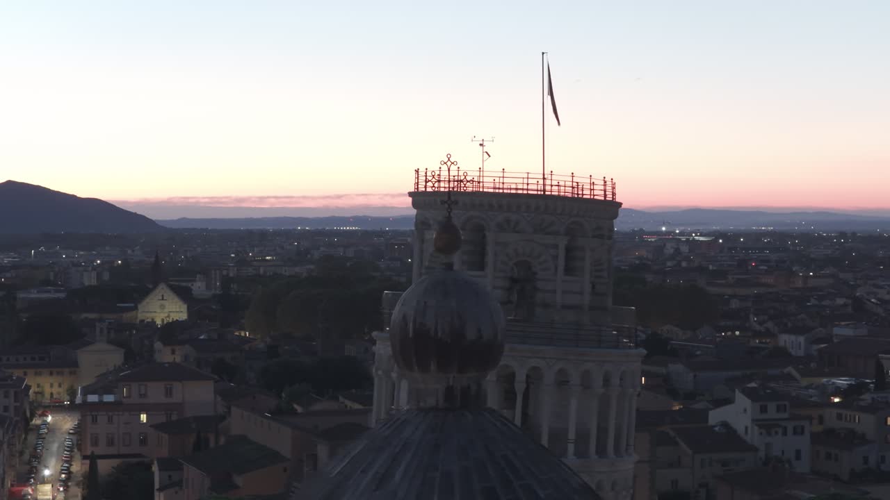 Cinematic sunrise drone footage of the Leaning Tower of Pisa and the Piazza dei Miracoli, captured with smooth aerial movements and soft early morning light