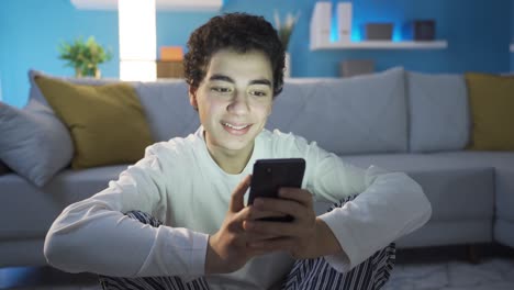 Boy-using-smartphone-in-fun-and-cheerful-mood.