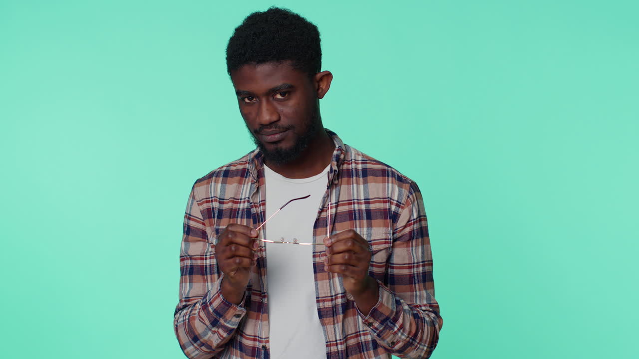 Playful happy man wearing sunglasses blinking eye looking at camera with smile, winking, flirting