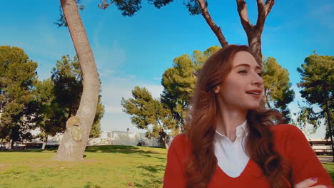 a happy, attractive, young, caucasian woman at the park, looking away from camera - very proud, accomplished, even as though she has the secret to success