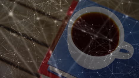 flat design coffee cup sitting on stacked blue and red books while network overlay linking nodes