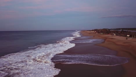 Aerial-dolly-in-low-altitude-at-Playa-Condesa-Beach,-Mexico-at-twilight