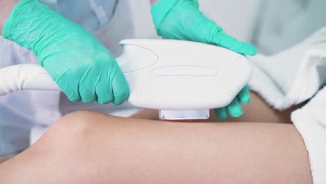 lady undergoes laser epilation of legs made by specialist