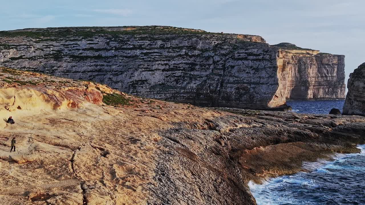 Cliffs and sea view in Malta during sunset with rocks and water