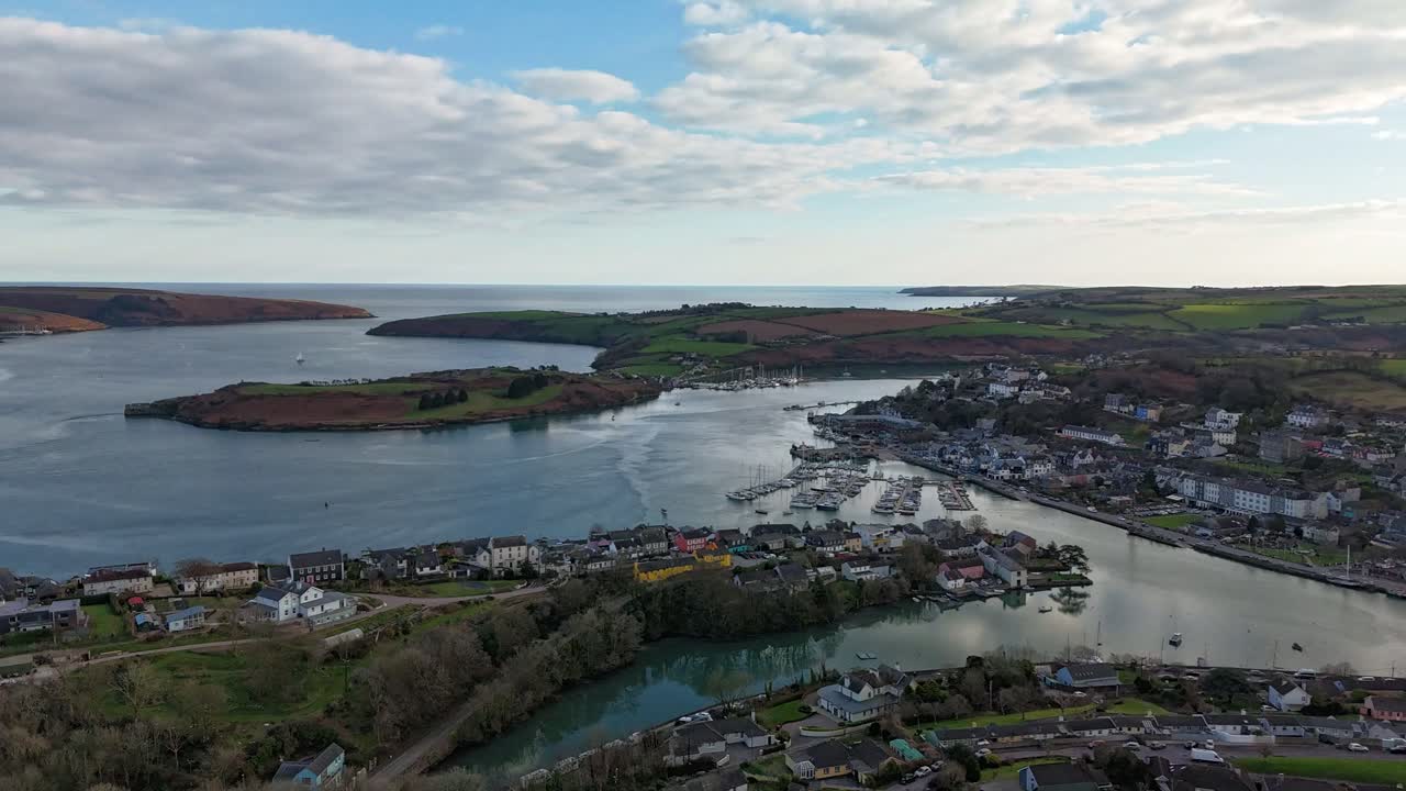 Drone hyperlapse over the picturesque marina and town of Kinsale, Ireland, Calm waters and blue sky,