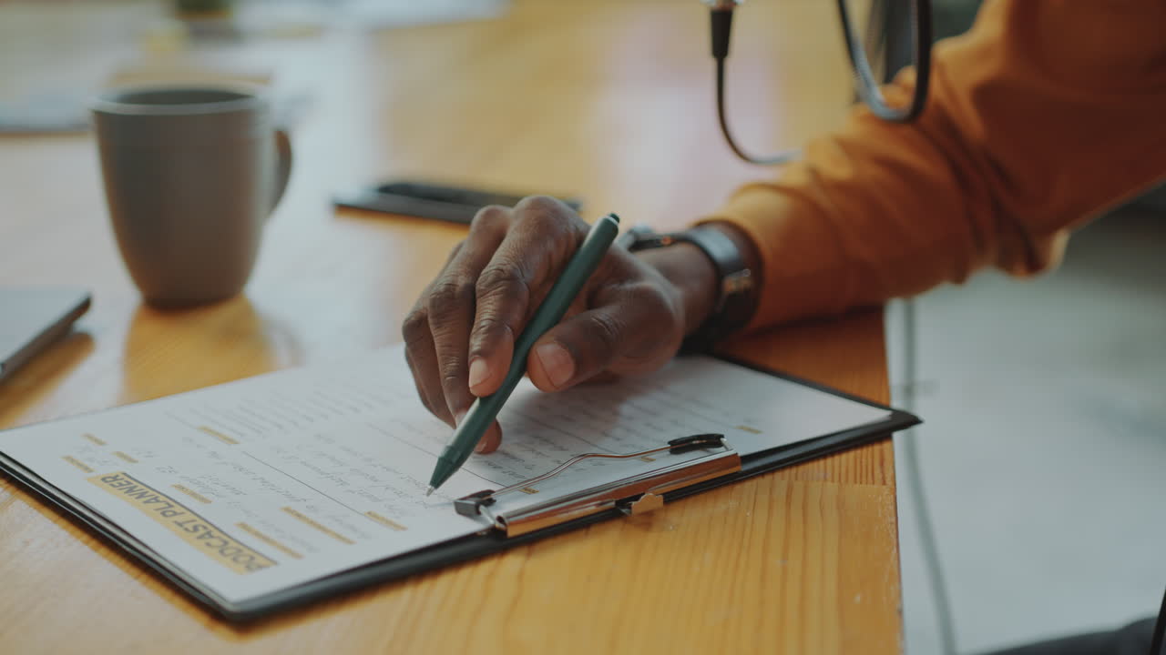 Hands of Podcast Host Proofreading Content Plan and Putting Marks