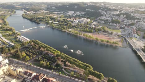 panoramic aerial view of mondego river and reveal of coimbra university buildings