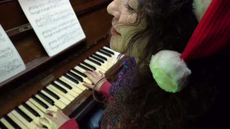 woman singing and playing piano during christmas