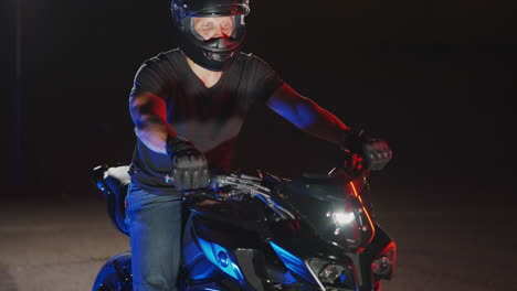 man riding motorcycle at night