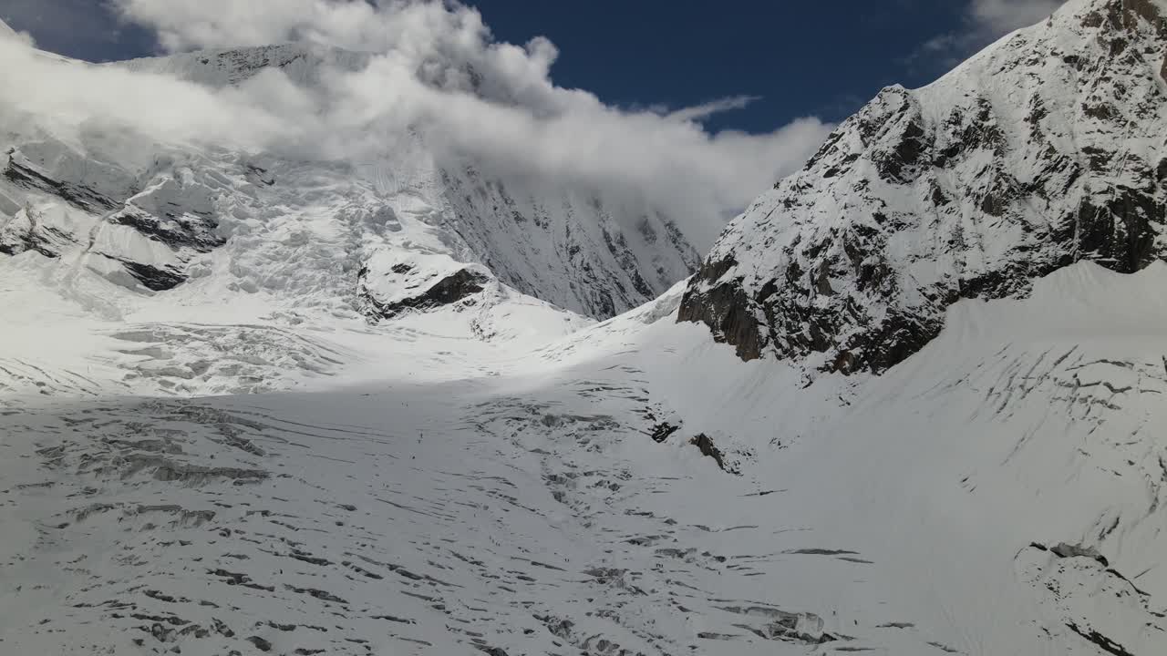 A stunning aerial view reveals the icy approach toward Mount Everest, where glacier textures and massive Himalayan peaks shape the dramatic high-altitude landscape of Nepal’s rugged mountains