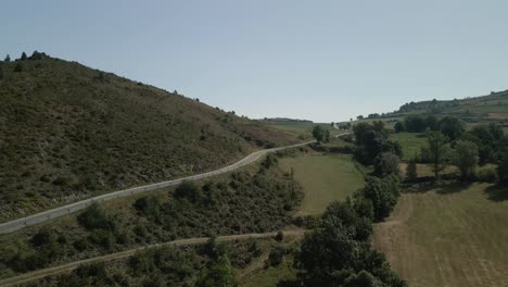 Aerial-view-following-a-mountain-road-on-the-countryside-in-Montella,-La-Cerdanya,-Catalunya