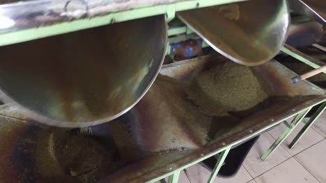 machine pouring dry tea raw to container