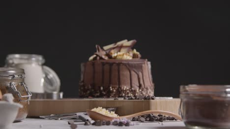 close up of kitchen with freshly baked and decorated chocolate celebration cake on work surface 2