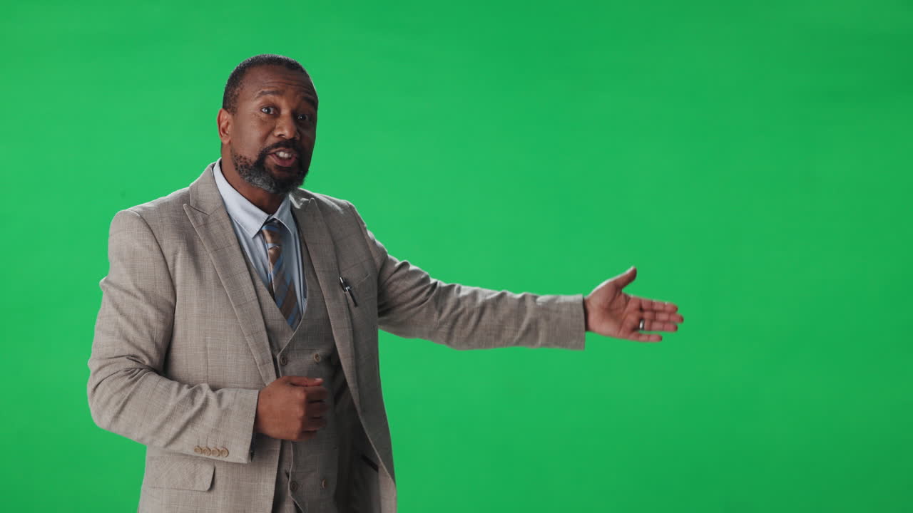 Man in suit giving presentation on green screen