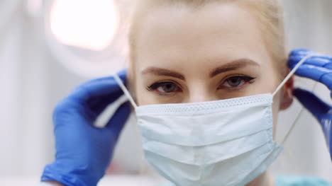 dentist putting on protective mask before surgery 4