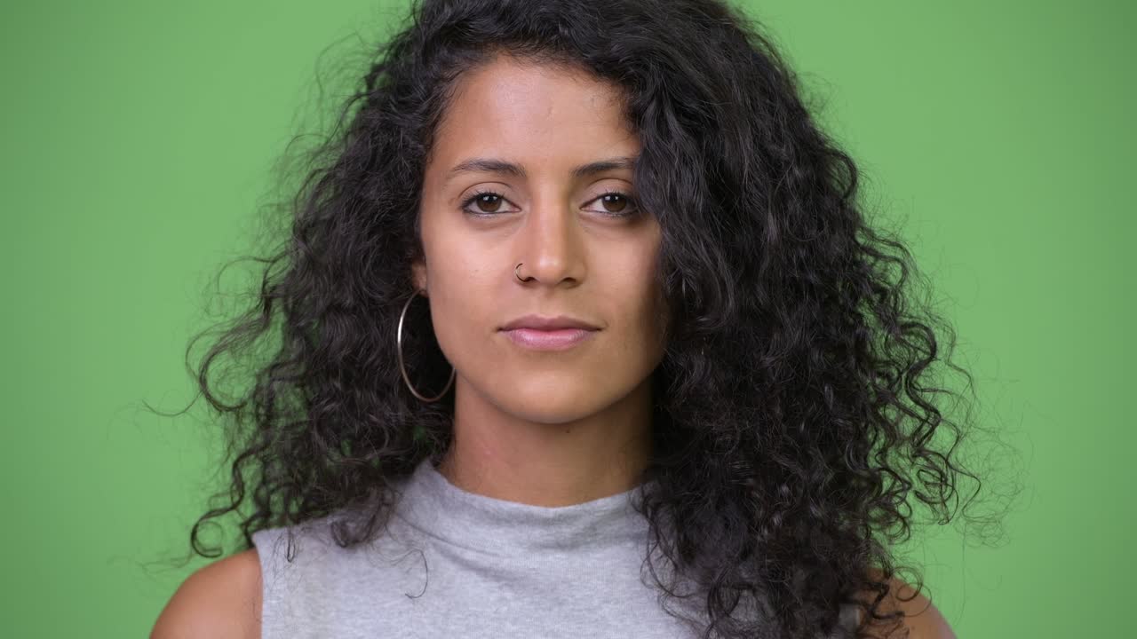 Young beautiful Hispanic woman with curly hair