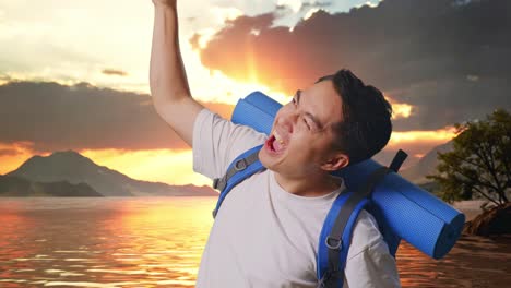 close up side view of asian male hiker with mountaineering backpack screaming goal celebrating the success at a lake