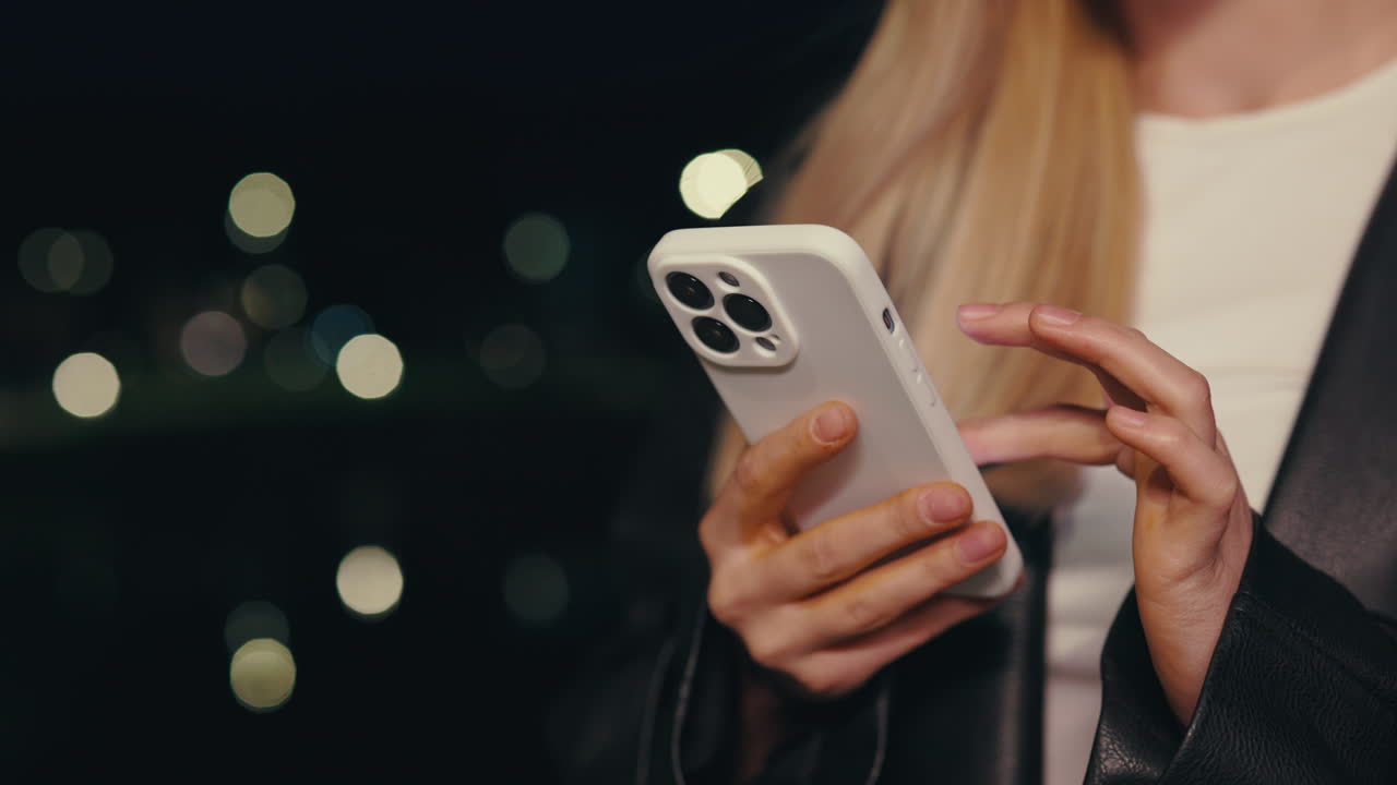 Woman using her smartphone at night