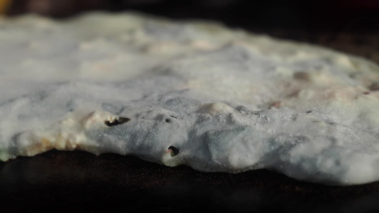 Close-up of Dough Bubbling While Cooking on a Hot Surface