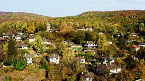 Idílico-Y-Tradicional-Pueblo-Forestal-Remoto-Búlgaro-En-Otoño-Con-Drones