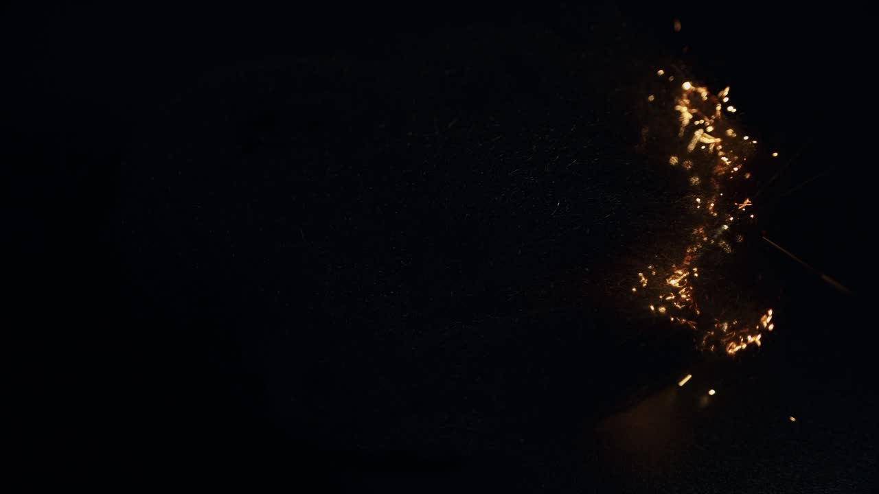 Hypnotic steel wool burning sparkles in darkness round bokeh