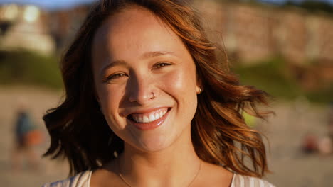 slow motion close-up bokeh shot of a beautiful woman smiling at canon beach