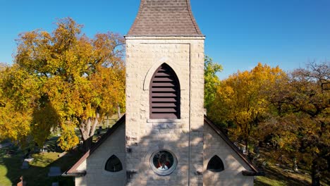 rural country chapel surrounded by beautiful autumn forest drone